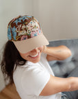 Woman wearing the I’m Sticking With Jesus floral snapback hat with a white top