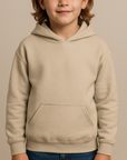 Child wearing a beige hoodie on a beige background