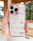 Phone case with motivational text held by a person indoors