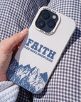Hand holding the Faith Can Move Mountains iPhone case against blue and white checked fabric