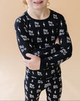 Child wearing a black outfit with 'Big Bro' text on a beige background