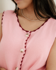 Model wearing Emerson pink sleeveless sweater vest with jeans