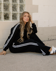 Black varsity stripe crewneck and sweatpants set with white contrast stripes