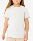 Young girl wearing a white Comfort Colors 9018 Youth Heavyweight T-Shirt on a neutral background — premium ringspun cotton blank ideal for custom printing by Lumiere Vive.