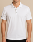 Male model wearing a white Adidas A230 Performance Polo on a neutral beige studio background — moisture-wicking polo ideal for embroidery or custom branding by Lumiere Vive.