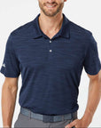 Man wearing a navy blue Adidas A402 Men’s Blend Polo on a neutral background — premium moisture-wicking performance polo ideal for embroidery or custom branding by Lumiere Vive.