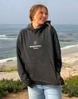 Model wearing black Always Sunny With Jesus unisex hoodie, front view