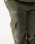 Side view of hunter green kids cargo sweatpants showing the cargo pocket