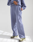Plum cotton sweatpants showing the relaxed wide leg fit and side pockets