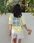 Back view of the Morning Sun Be the Light tee showing blue graphics and lettering