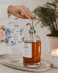 Blue floral Best Mom Ever mug beside a glass French press and candle