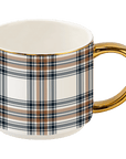 Cream coffee mug with orange and navy plaid stripes and a gold handle