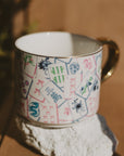Mahjong coffee mug with colorful tile illustrations styled on a stone surface