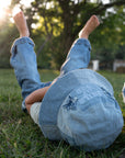 Child of God patchwork denim bucket hat with star appliqués photographed outdoors