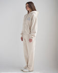 Side view of the oversized Child of God full-zip hoodie styled with coordinating pants