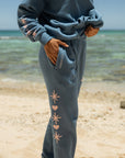 Side view of Stellar Blue Sweatpants featuring contrasting starburst graphics down one leg