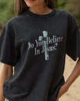 Close-up of a black heavyweight tee featuring a cross graphic and Do You Believe in Jesus lettering.