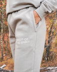 Gray sweatpants with 'Fruit of the Spirit' text in an autumn forest setting