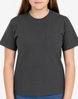Young woman wearing a charcoal Gildan Heavy Cotton Pocket T-Shirt, showcasing a relaxed unisex fit and durable fabric — ideal for custom printing by Lumiere Vive.