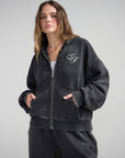 Front view of the black God of Miracles Hoodie showing its full zipper, chest embroidery, and front pockets.