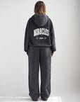 Back view of the black God of Miracles Hoodie showing bold light-colored lettering.