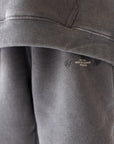 Close-up of subtle graphic details on Grey Mist God of Miracles Kids Sweatpants