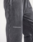 Close-up of Elevated Faith lettering embroidered on the black sweatpants.