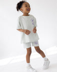 Child wearing the God’s Plan Racing Icicle kids tee with a purple chest graphic
