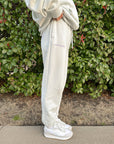Side profile of the relaxed-fit God’s Plan Racing Icicle Sweatpants with cuffed ankles