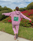 Back view of the Bordeaux God’s Promises Hoodie showing its colorful landscape graphic, styled with coordinating pants.