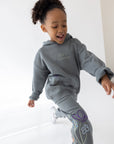 Child wearing a Sedona Sage hoodie with coordinating floral sweatpants.