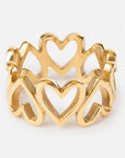 Gold ring with heart designs on a white background