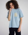 Model wearing the Holy Ghost Sterling Blue heavyweight tee with a small yellow chest graphic