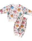 Baby outfit with smiley face pattern on a white background