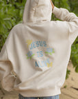 Back detail of the Nimbus Cloud Jesus Is Alive hoodie with blue lettering and pastel flowers