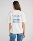 Back view of the Jesus Loves New York Early Frost tee with bold lettering and a blue city skyline graphic.