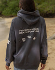 Back detail of the Black Tide Jesus Wins Hoodie showing He Conquered Death Forever lettering and small graphics