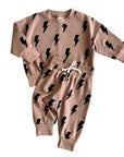 Children's sweatshirt and pants set with black bolt pattern on a beige background