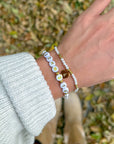 John 3:16 beaded bracelet set worn together on a wrist with a light knit sleeve outdoors
