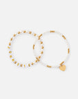 Two John 3:16 coordinating bracelets laid flat, showing letter beads and a gold-tone heart charm