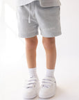 Front detail of Kingdom Club Open Air blue kids’ shorts with a drawstring waist and white Elevated Faith lettering.