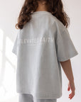 Back view of the Kingdom Club Open Air Blue Kids Tee with white Elevated Faith lettering