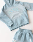 Flat lay of the Air Blue Kingdom Kids Hoodie beside coordinating pants