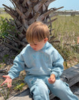 Closer view of a child wearing the Air Blue Kingdom Kids Hoodie outdoors