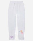 White sweatpants with embroidered designs on a white background