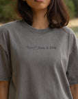 Front detail of Not Sorry Jesus Is King grey tee with embroidered lettering