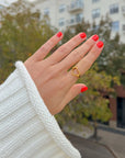 Open Heart Ring worn on a hand with red nails outdoors