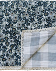 Floral patterned blanket with a checkered reverse side and lace trim