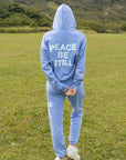 Full-length back view of the Mountain Bluebird hoodie styled with coordinating blue sweatpants.