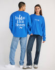 Man and woman modeling the blue Pray for Los Angeles long sleeve tee, showing the front and back designs.